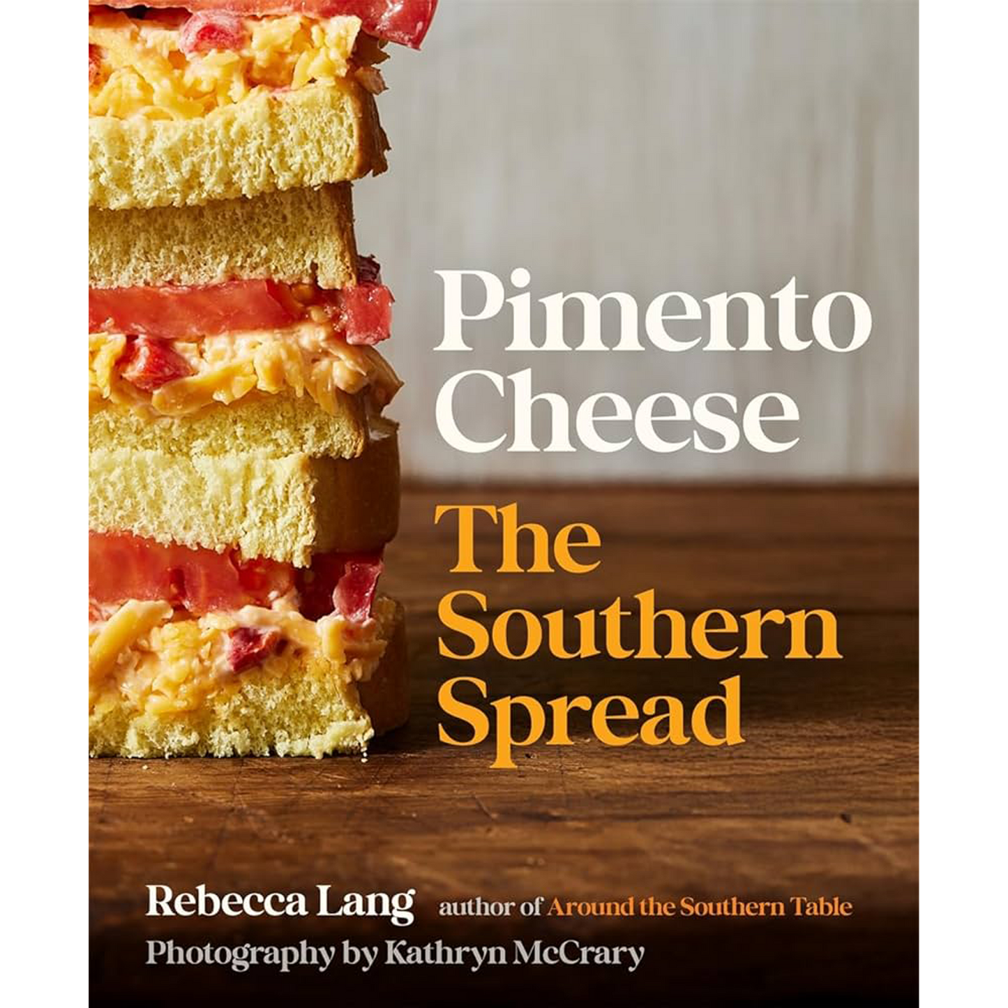 Book cover of 'Pimento Cheese: The Southern Spread' with a slice of layered cheese on a wooden surface.