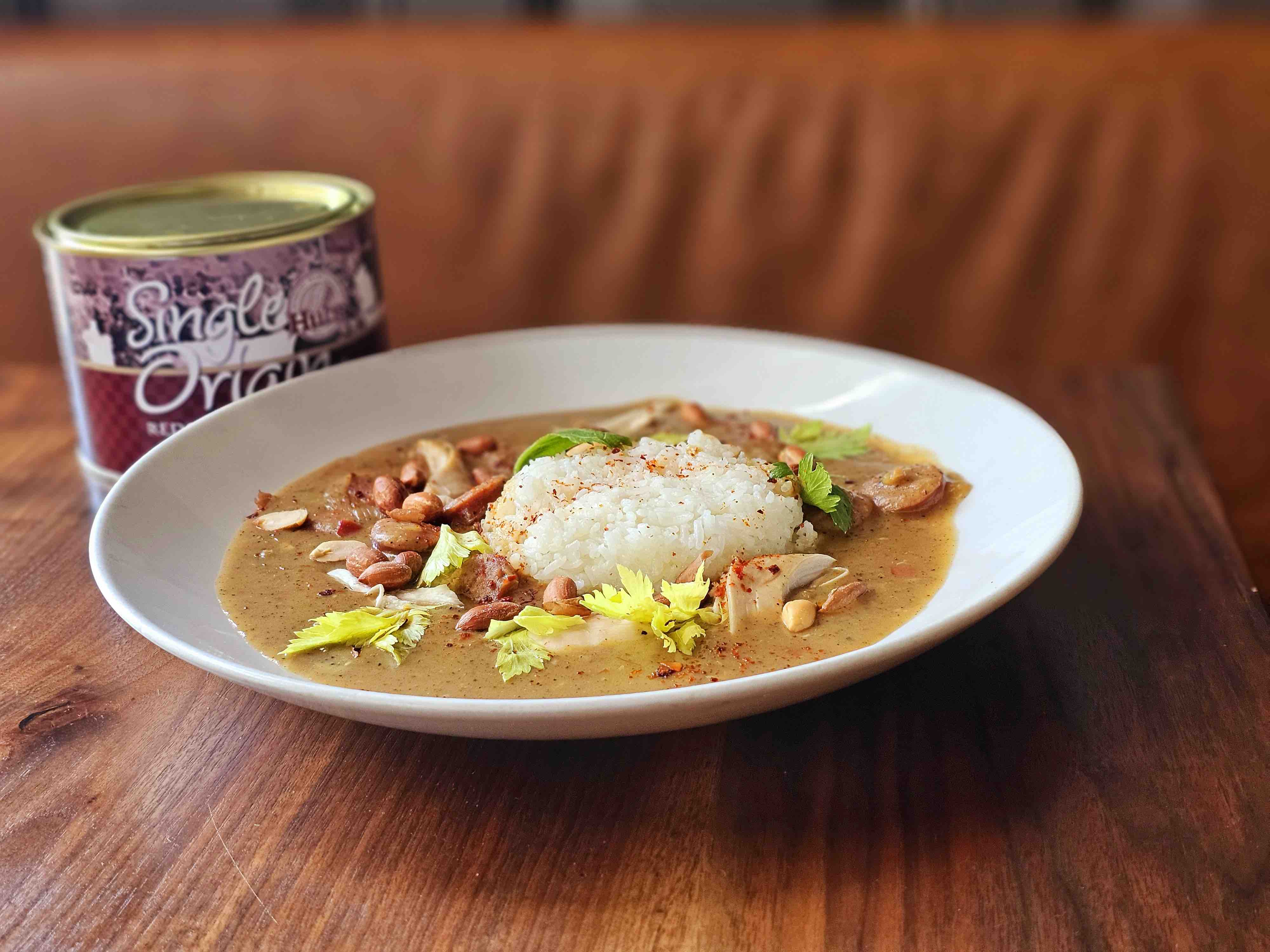 a bowl filled with chicken and peanut stew