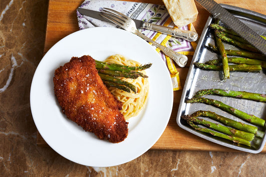 Chef Goodenough's Paneed Pork Chops plated with pasta and asparagus