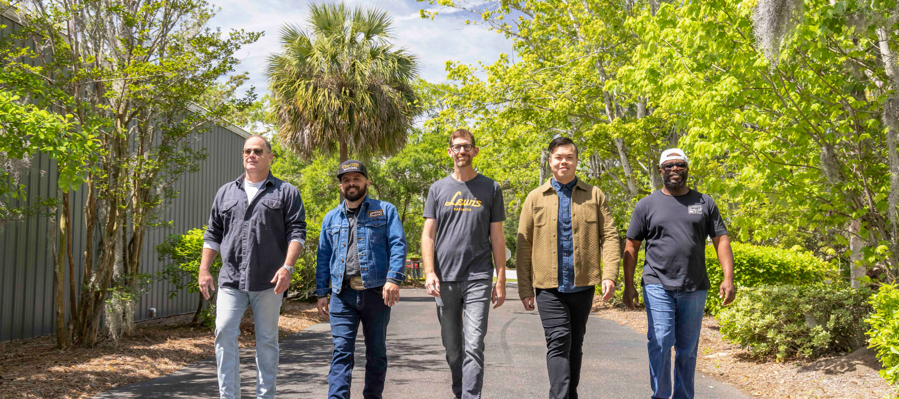 Five BBQ chefs walking toward the camera for TLP's Insider's Guide to Charleston Issue