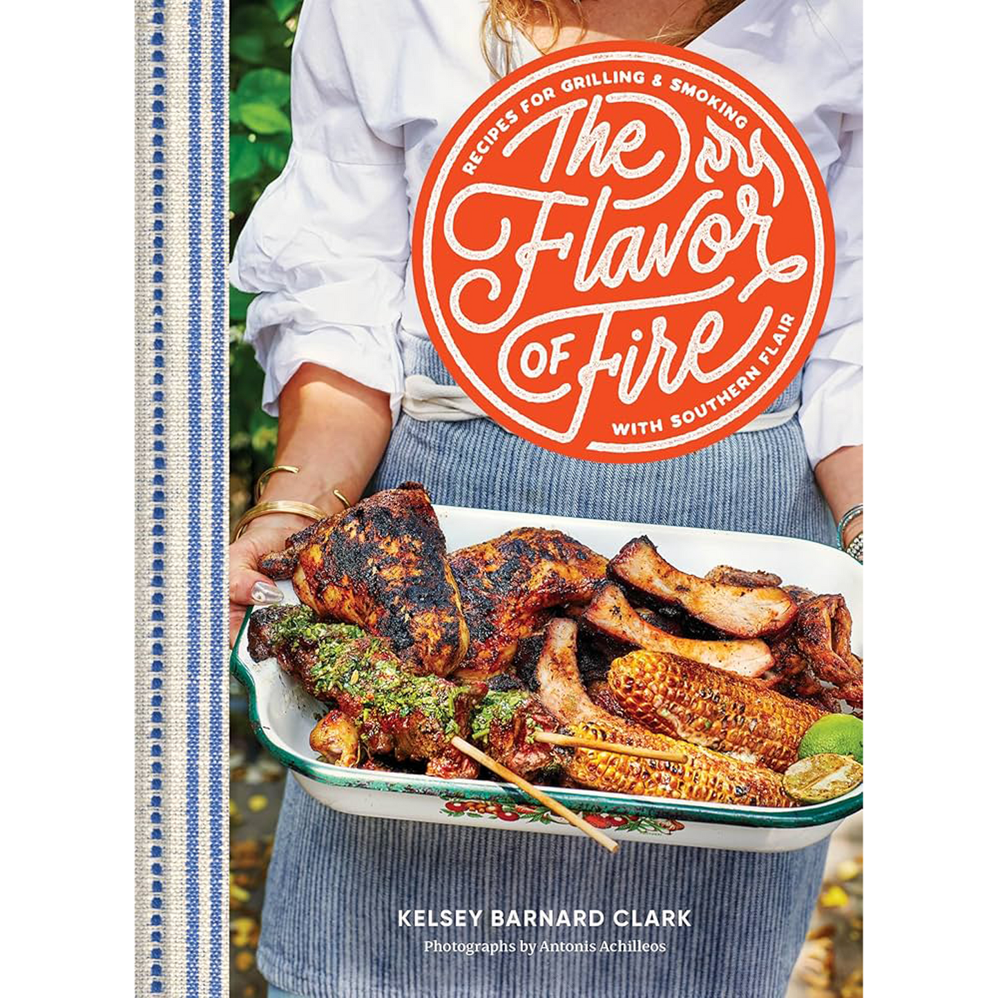 Book cover of 'The Flavor of Fire' with a person holding grilled food.