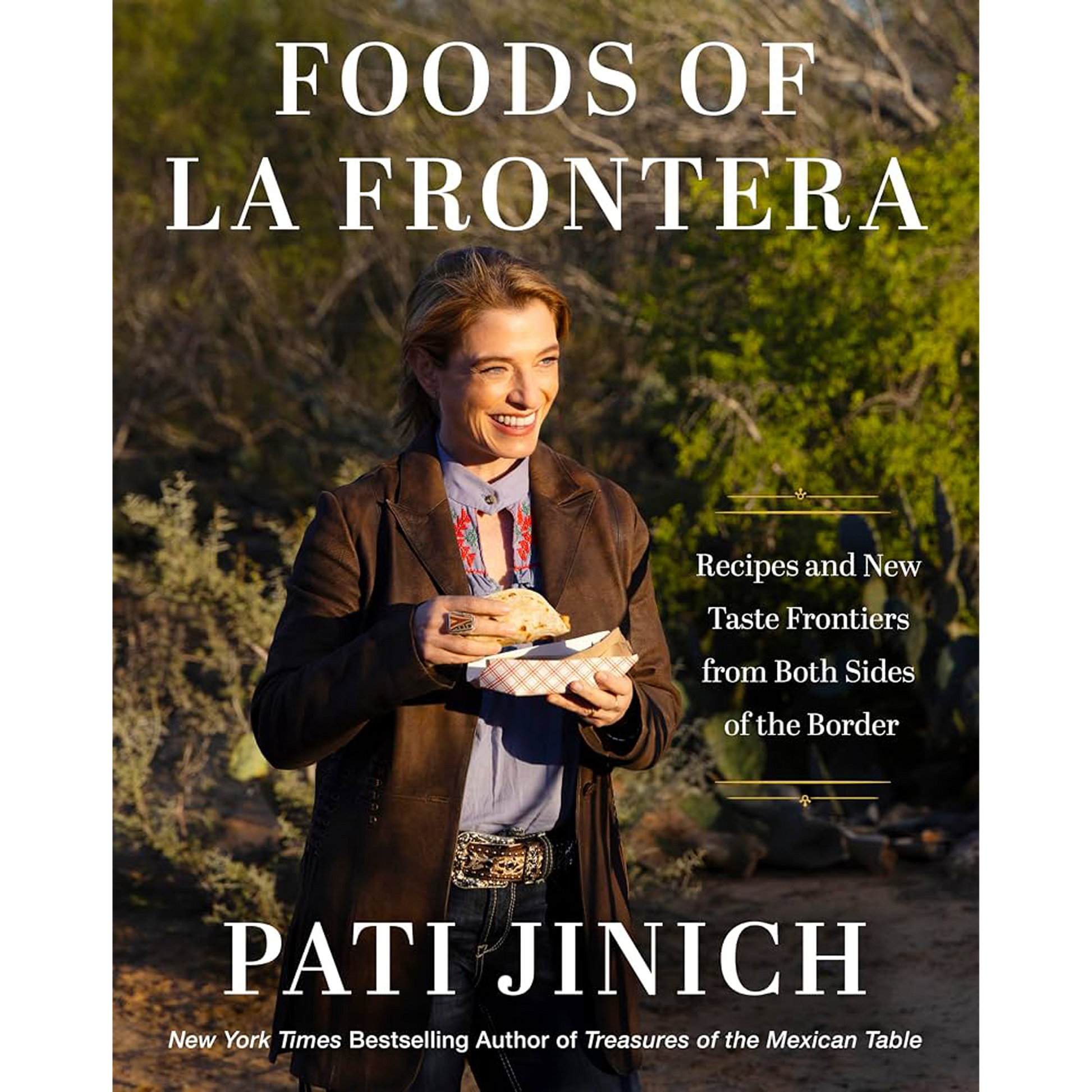 Book cover for 'Foods of La Frontera' by Pati Jinich, featuring a photo of the author outdoors holding a food item, with large white title text and subtitle text on a natural background.