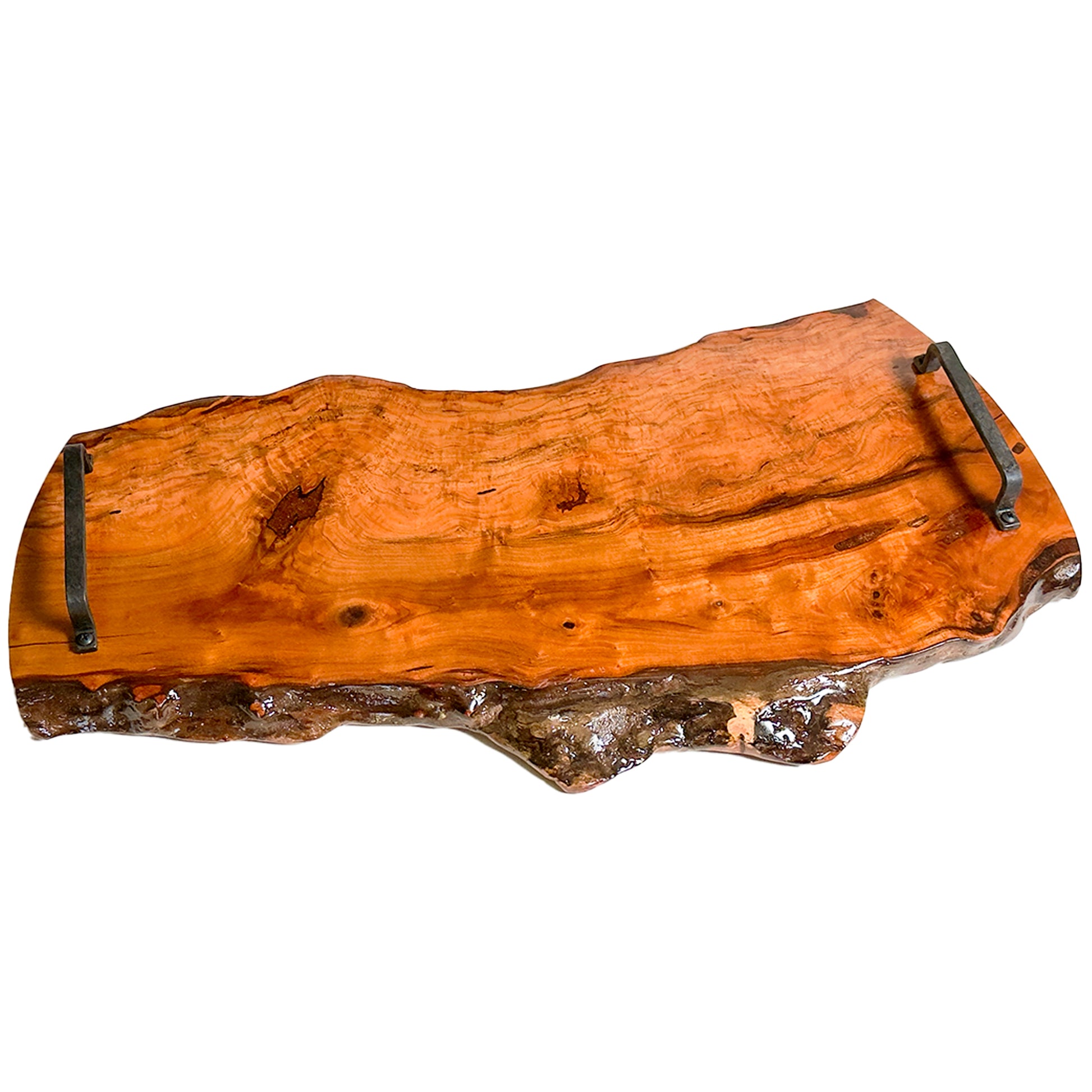 13 inch by 29 inch Pecan wood cutting board with natural edge and metal handles on a white background