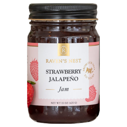 A jar of "Raven's Nest Strawberry Jalapeño Jam" with a white label featuring the brand logo